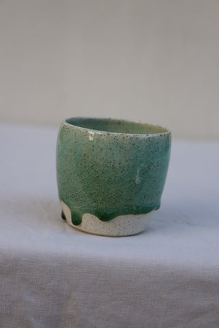 Speckled latte cup in ocean