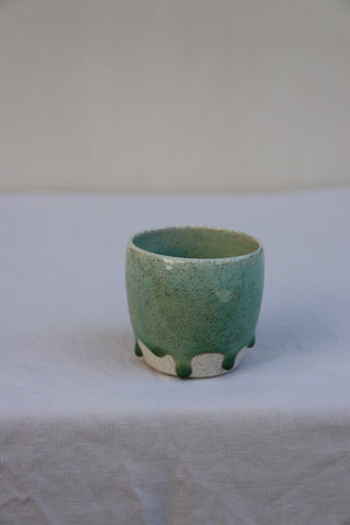 Speckled latte cup in ocean