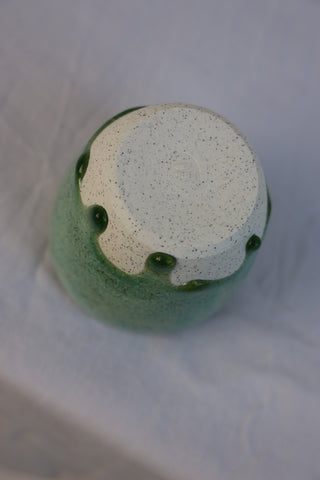 Speckled latte cup in ocean