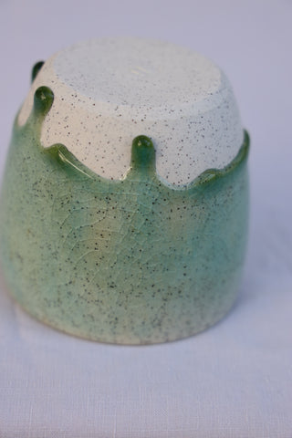 Speckled latte cup in ocean