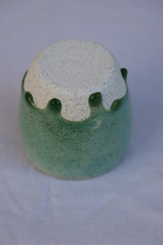 Speckled latte cup in ocean