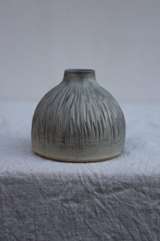 Carved vase in grey