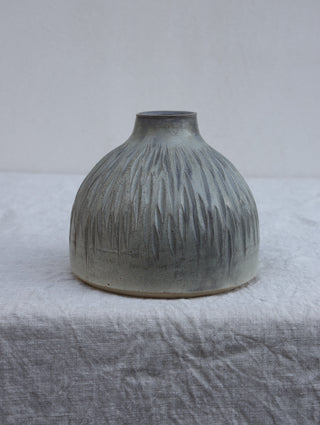 Carved vase in grey