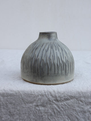 Carved vase in grey