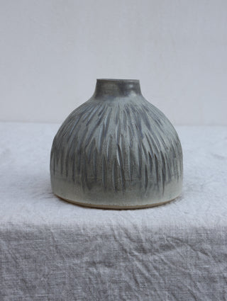Carved vase in grey