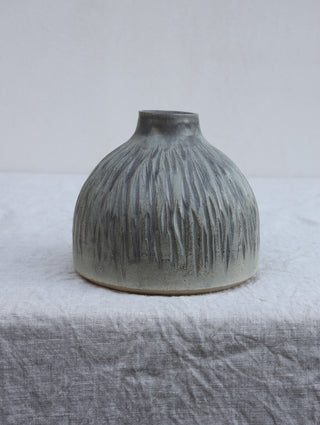 Carved vase in grey