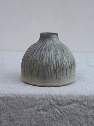 Carved vase in grey