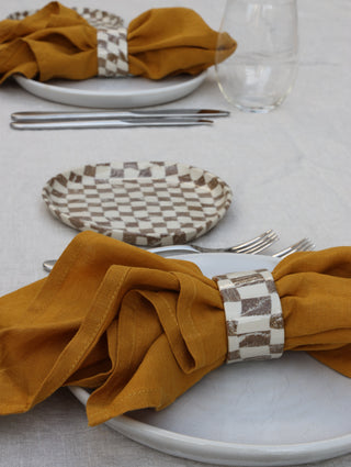 Set of four Chickedey-Checkedey plates with matching napkin rings