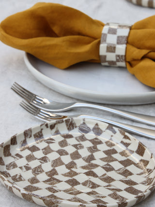 Set of four Chickedey-Checkedey plates with matching napkin rings