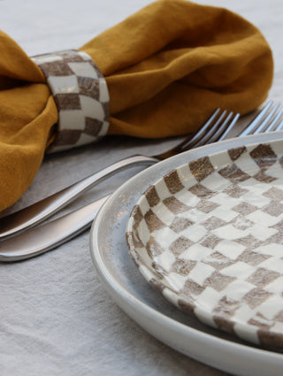 Set of four Chickedey-Checkedey plates with matching napkin rings