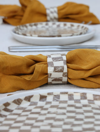 Set of four Chickedey-Checkedey plates with matching napkin rings