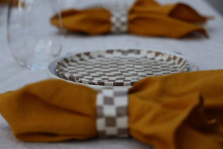 Set of four Chickedey-Checkedey plates with matching napkin rings